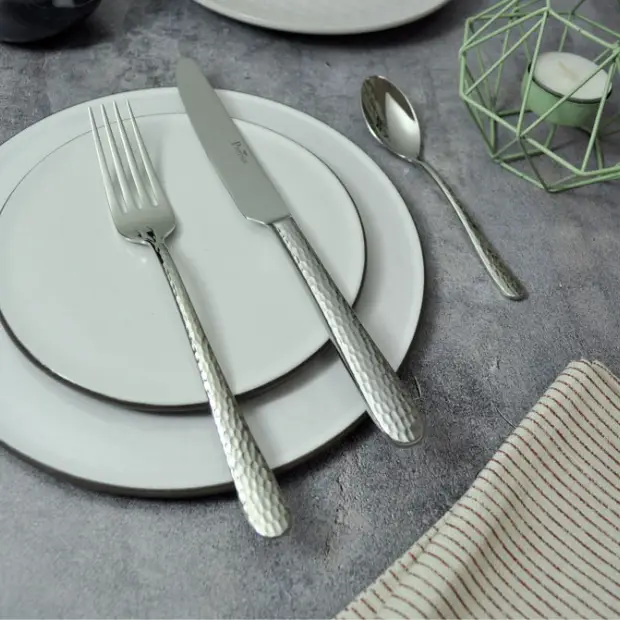 Glassware UK Pintinox Luna steel cutlery set with 24 pieces, including forks, knives, and spoons arranged on a clean surface.