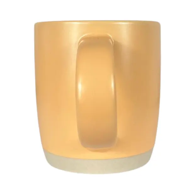 Ceramic coffee mug in peach color with "Glassware UK" branding, featuring a smooth, rounded shape and a sturdy handle.