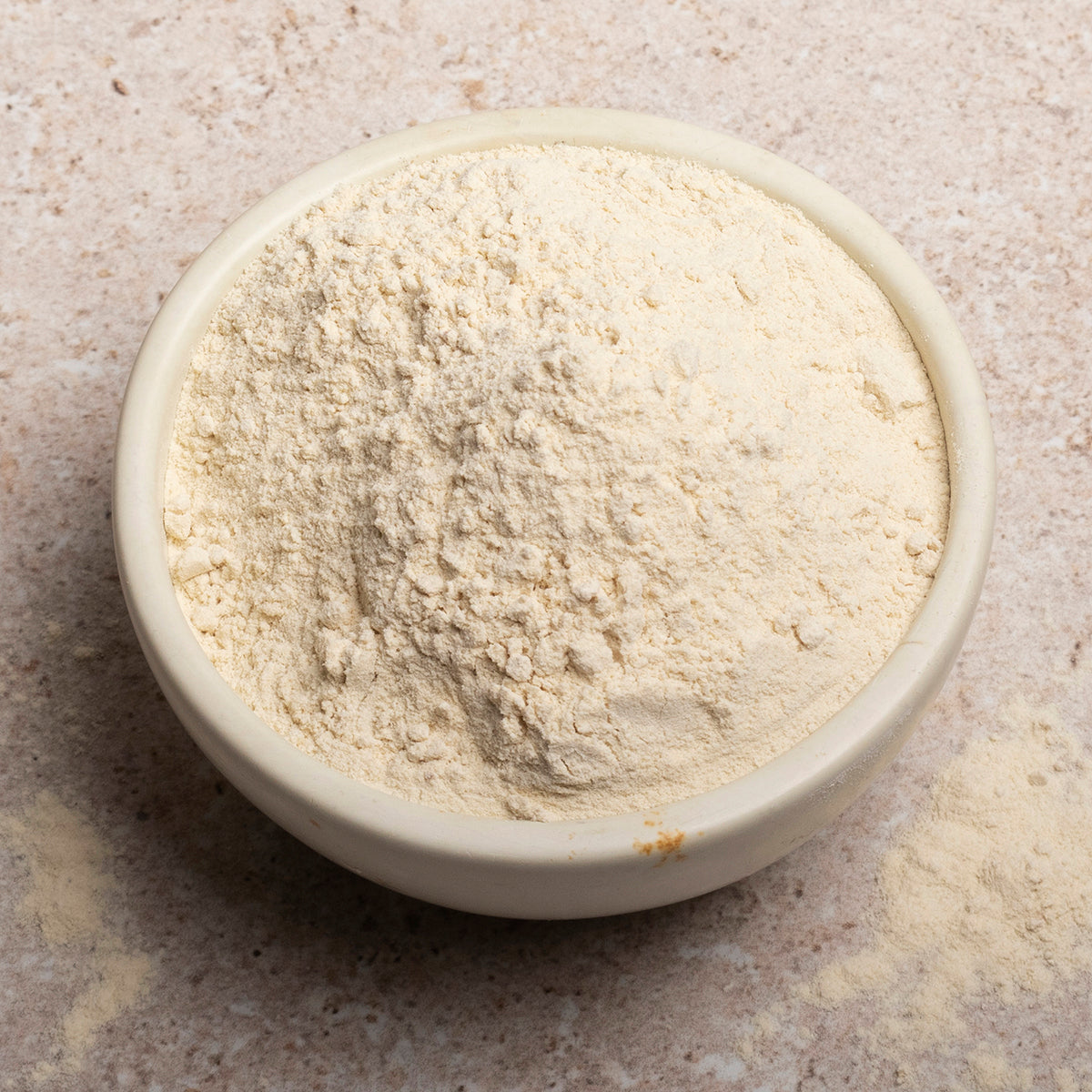 Vital wheat gluten flour from Serious Grains by Whole Food Earth, close-up of gluten powder in a container.