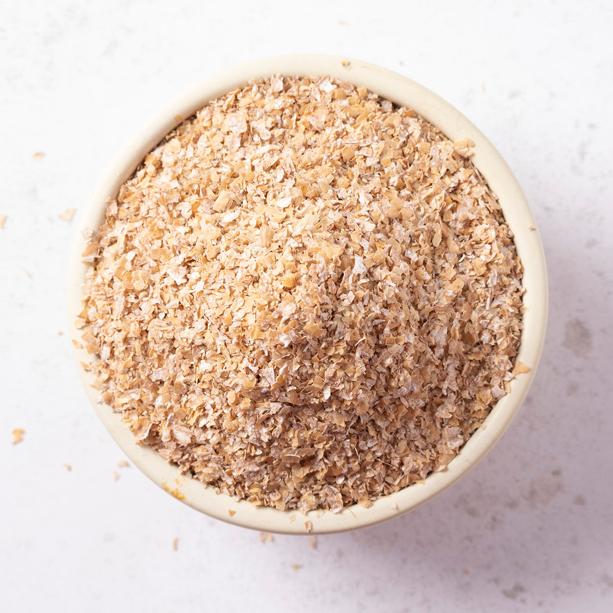 Whole Food Earth wheat bran medium cereal in a bowl, showcasing its light, flaky texture and natural wheat color.
