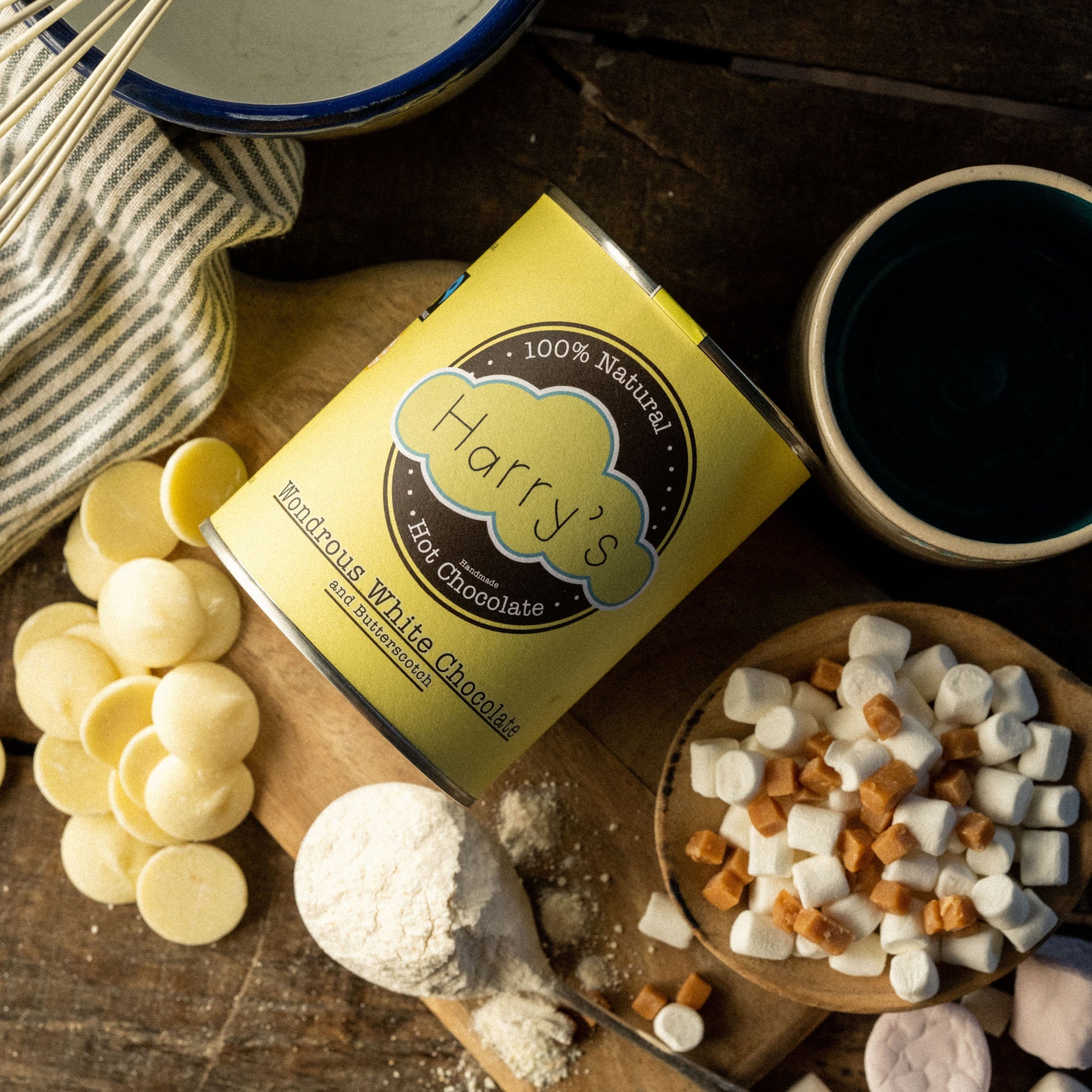 White tin of Harry's Hot Chocolate with 30% cocoa, featuring a clean design and a serving scoop on a cozy background.