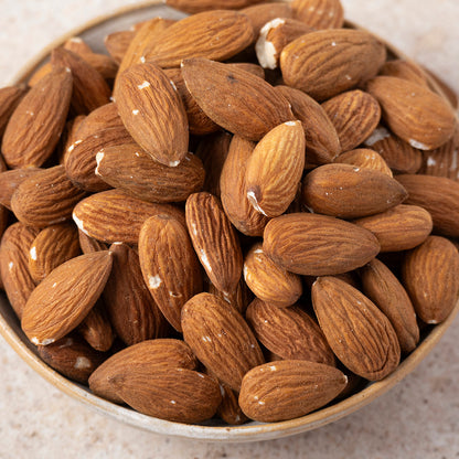 Whole Food Earth natural almonds in a bowl, showing their whole, unprocessed appearance as healthy nuts and seeds.