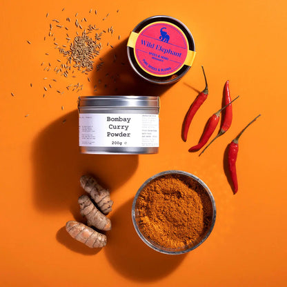 Close-up of Wild Elephant Bombay Curry Powder in a jar, highlighting the vibrant spice blend from Whole Food Earth.