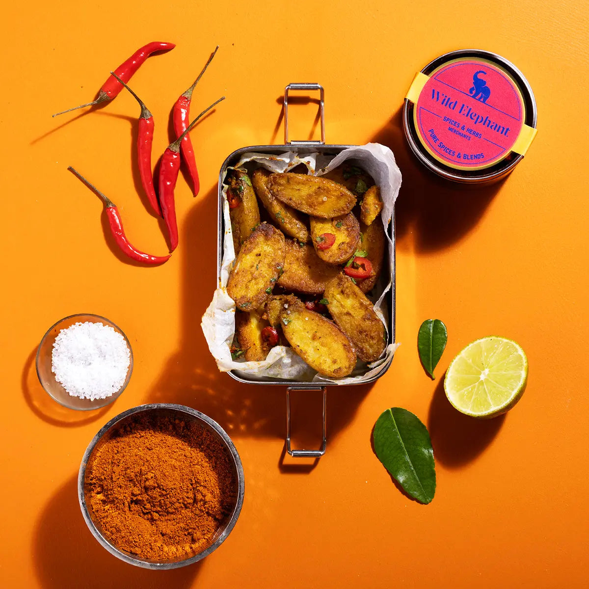 Wild Elephant Bombay Curry Powder from Whole Food Earth, a vibrant blend of spices in a jar, ideal for flavorful Indian dishes.