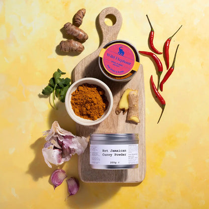 Jar of Wild Elephant Hot Jamaican Curry Powder, a spicy seasoning from Whole Food Earth, with vibrant yellow-orange spice blend visible