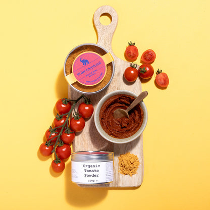 Organic Tomato Powder by Wild Elephant, Whole Food Earth, showing vibrant red tomato powder in a jar with a natural background.