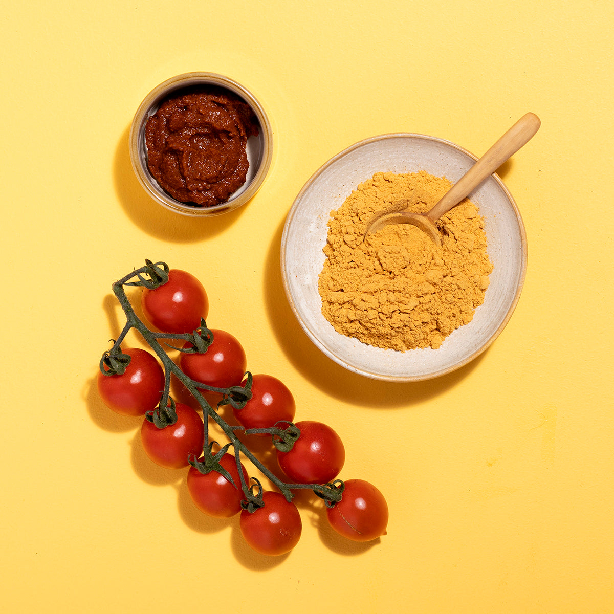 Organic tomato powder from Wild Elephant, packaged in herbs and spices, displayed in a clear container with a natural background.