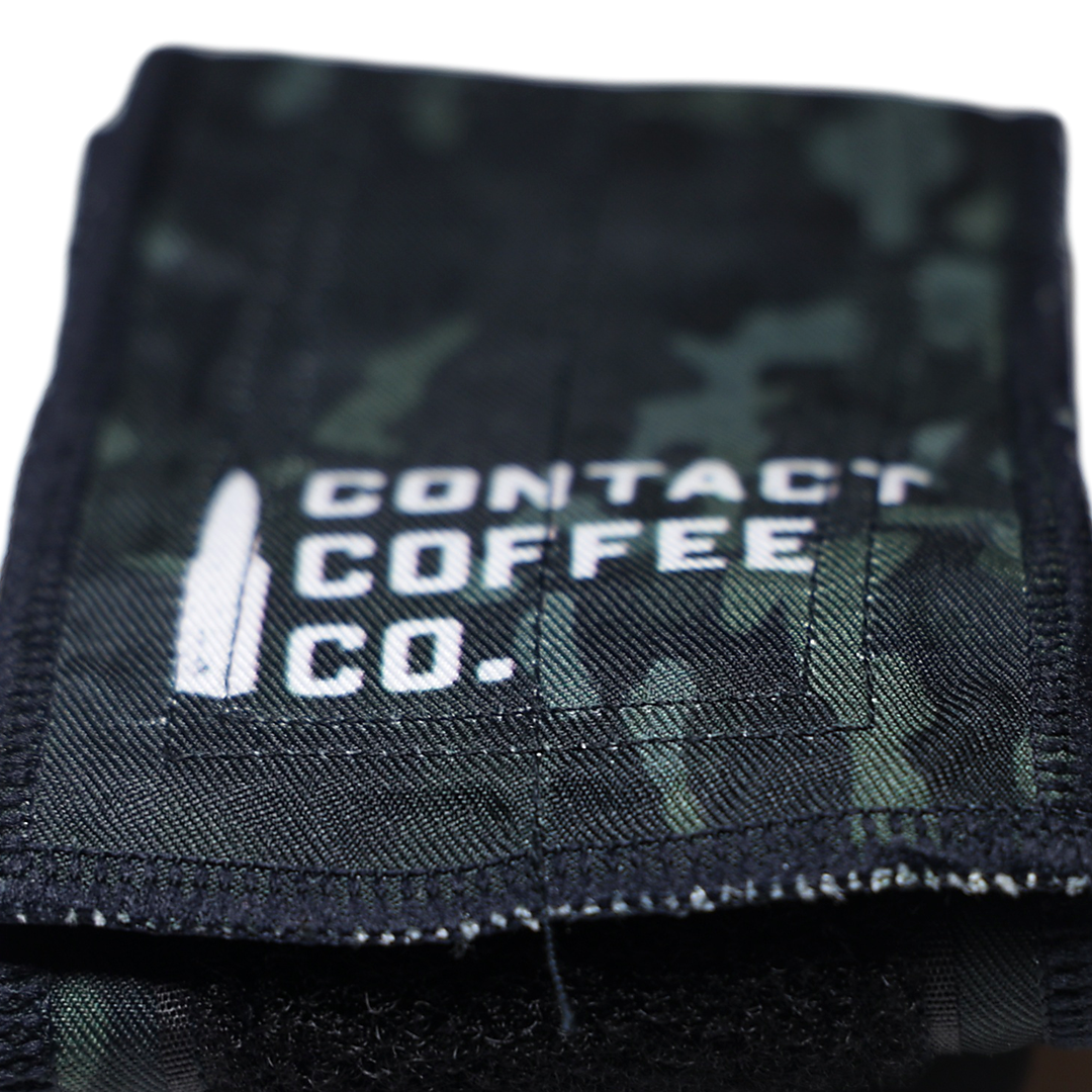 Close-up of camouflage gym wrist wraps by Contact Coffee Company Ltd., showing the fabric and stitching details.