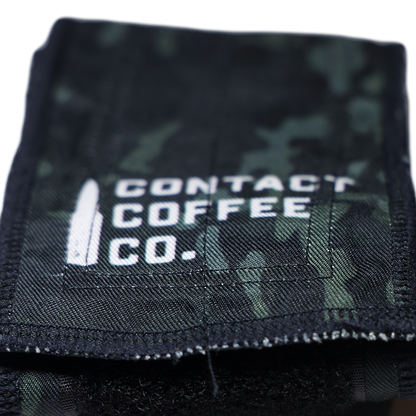 Close-up of camouflage gym wrist wraps by Contact Coffee Company Ltd., showing the fabric and stitching details.