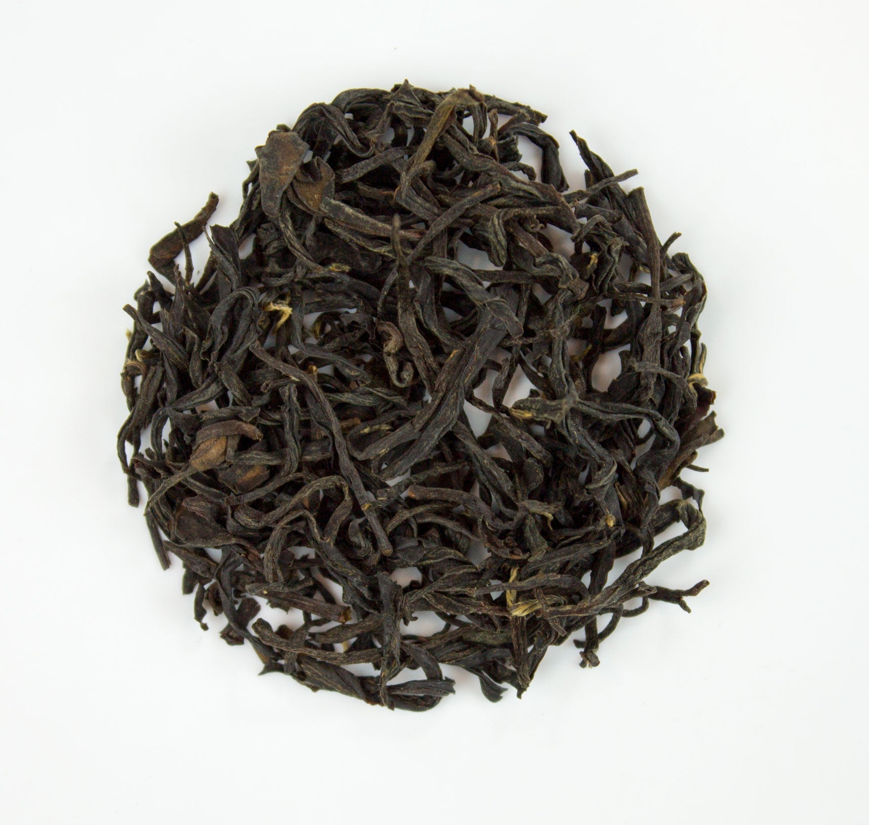 Handmade Zhou Family Wuyi Wild Lapsang Souchang tea from PekoeTea Edinburgh, featuring dark, smoky tea leaves in a traditional package.
