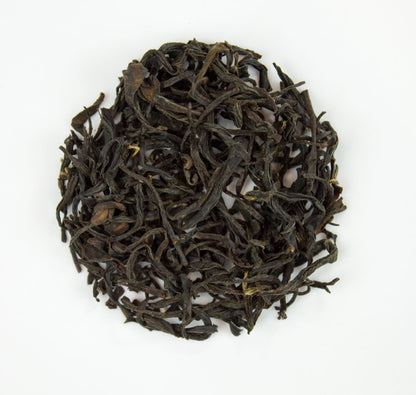 Handmade Zhou Family Wuyi Wild Lapsang Souchang tea from PekoeTea Edinburgh, featuring dark, smoky tea leaves in a traditional package.