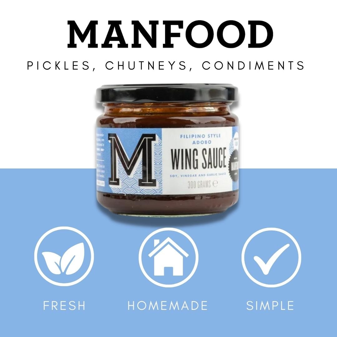 Bottle of Manfood Adobo Wing Sauce showing the label and dark reddish-brown sauce inside the bottle.