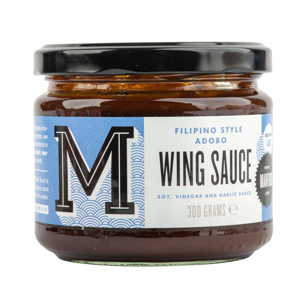 Manfood Adobo Wing Sauce in a jar, showcasing its rich, flavorful sauce with a spicy and savory appearance.