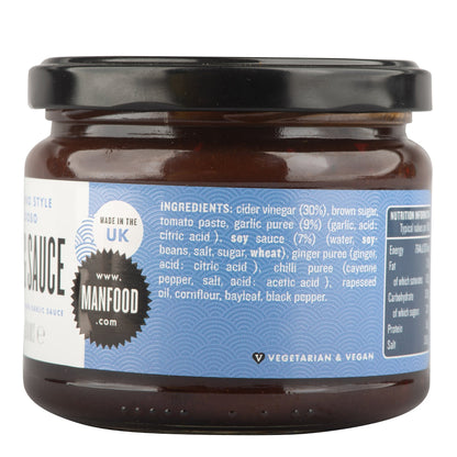 Manfood Adobo Wing Sauce in a jar, showcasing the rich, flavorful sauce with a vibrant label and a spoon ready for serving.