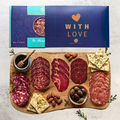 Bray Cured Adventure Feasting Five charcuterie selection on a wooden board with festive Christmas sleeves.