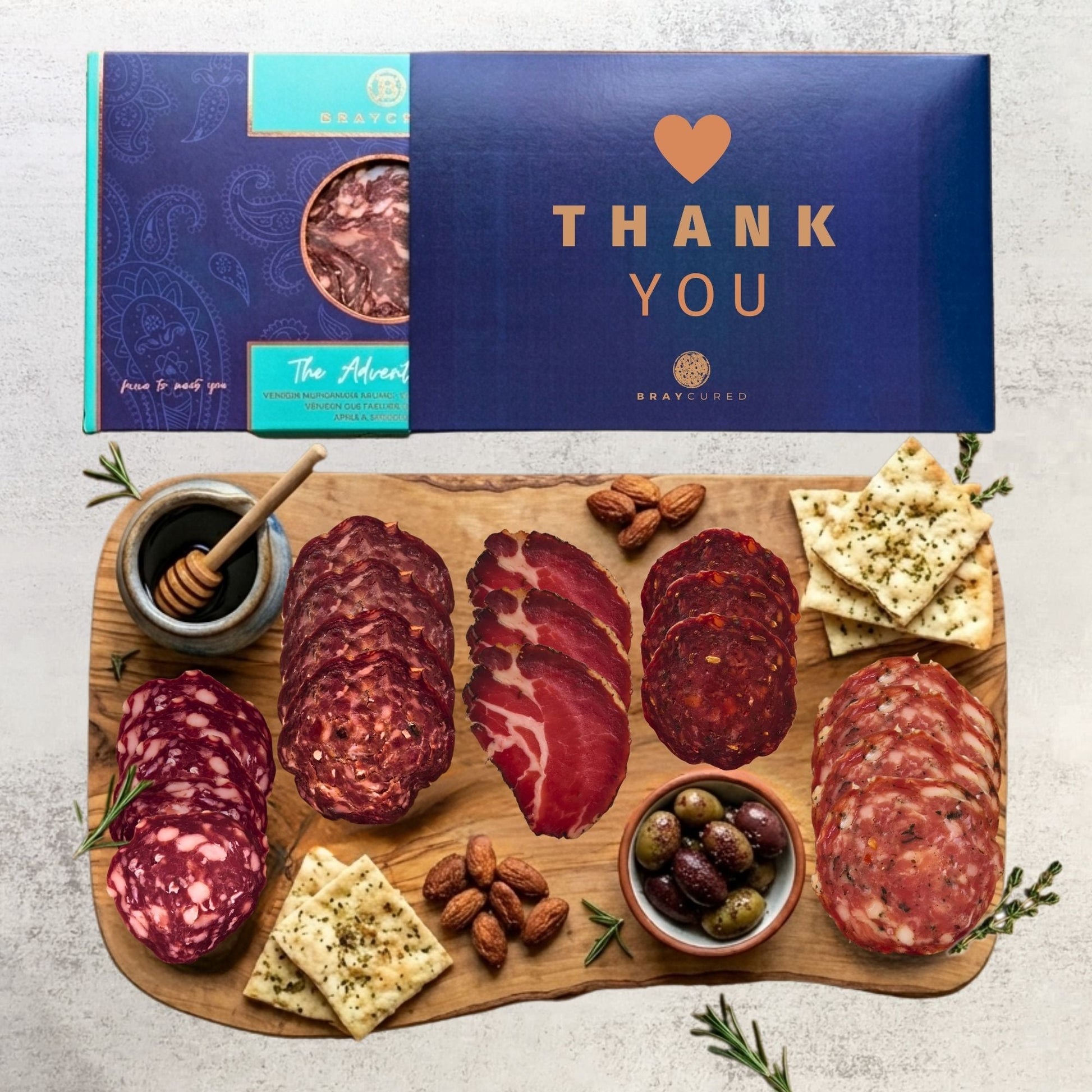 Bray Cured Adventure Feasting Five charcuterie selection on holiday-themed board with Christmas sleeve, featuring meats and accompaniments.