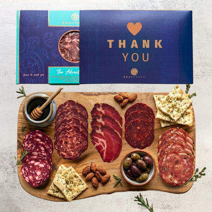 Bray Cured Adventure Feasting Five charcuterie selection on holiday-themed board with Christmas sleeve, featuring meats and accompaniments.