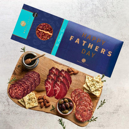 Bray Cured Adventure Tasting Trio charcuterie selection with meats and accompaniments on a wooden board, ideal for sharing.