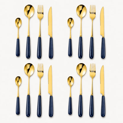 A 16-piece gold cutlery set by KitchBoom with midnight navy handles, including forks, knives, spoons, and teaspoons arranged on a table.