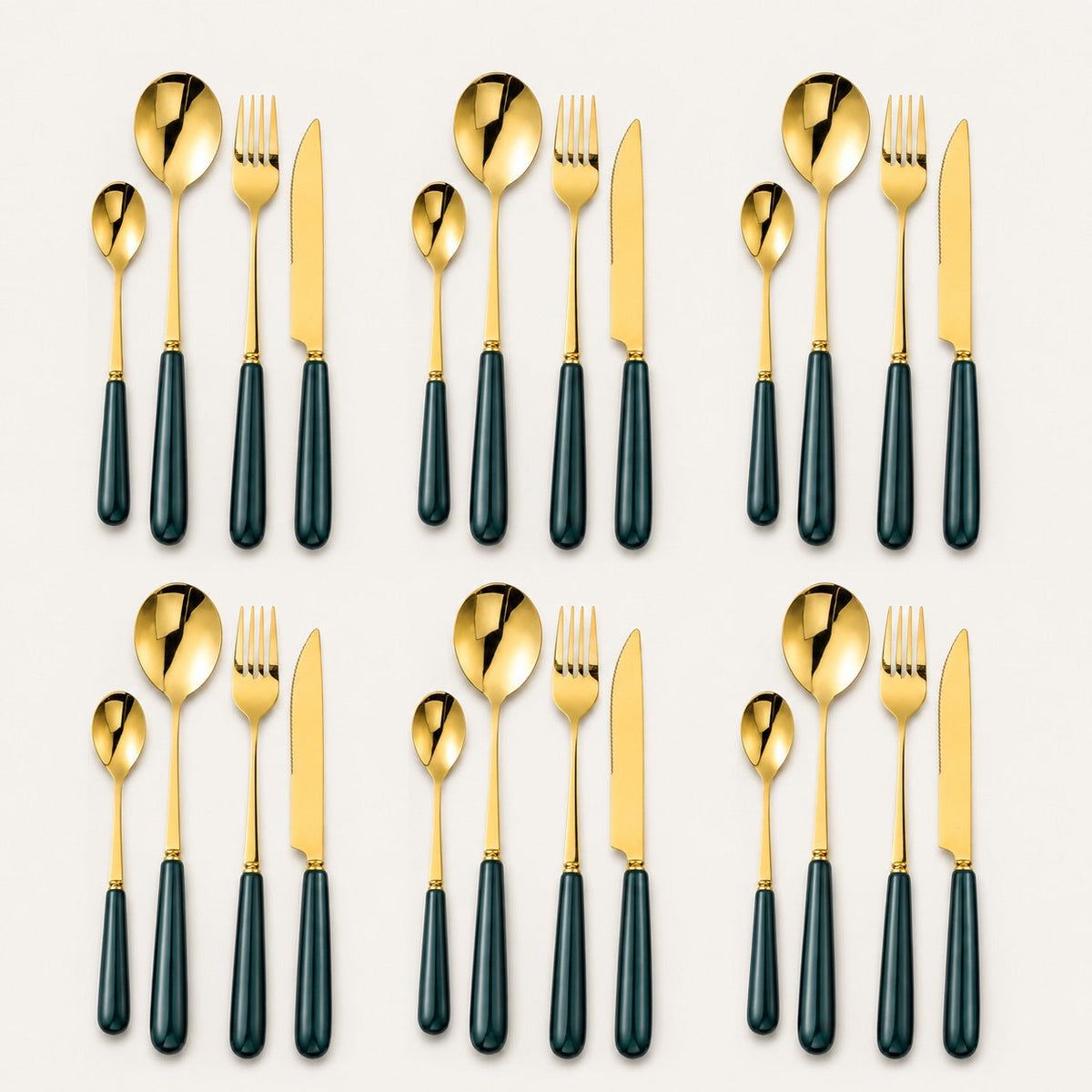 KitchBoom Aldermere 24-piece gold cutlery set with forest green handles, including forks, knives, spoons, and teaspoons arranged on a table.