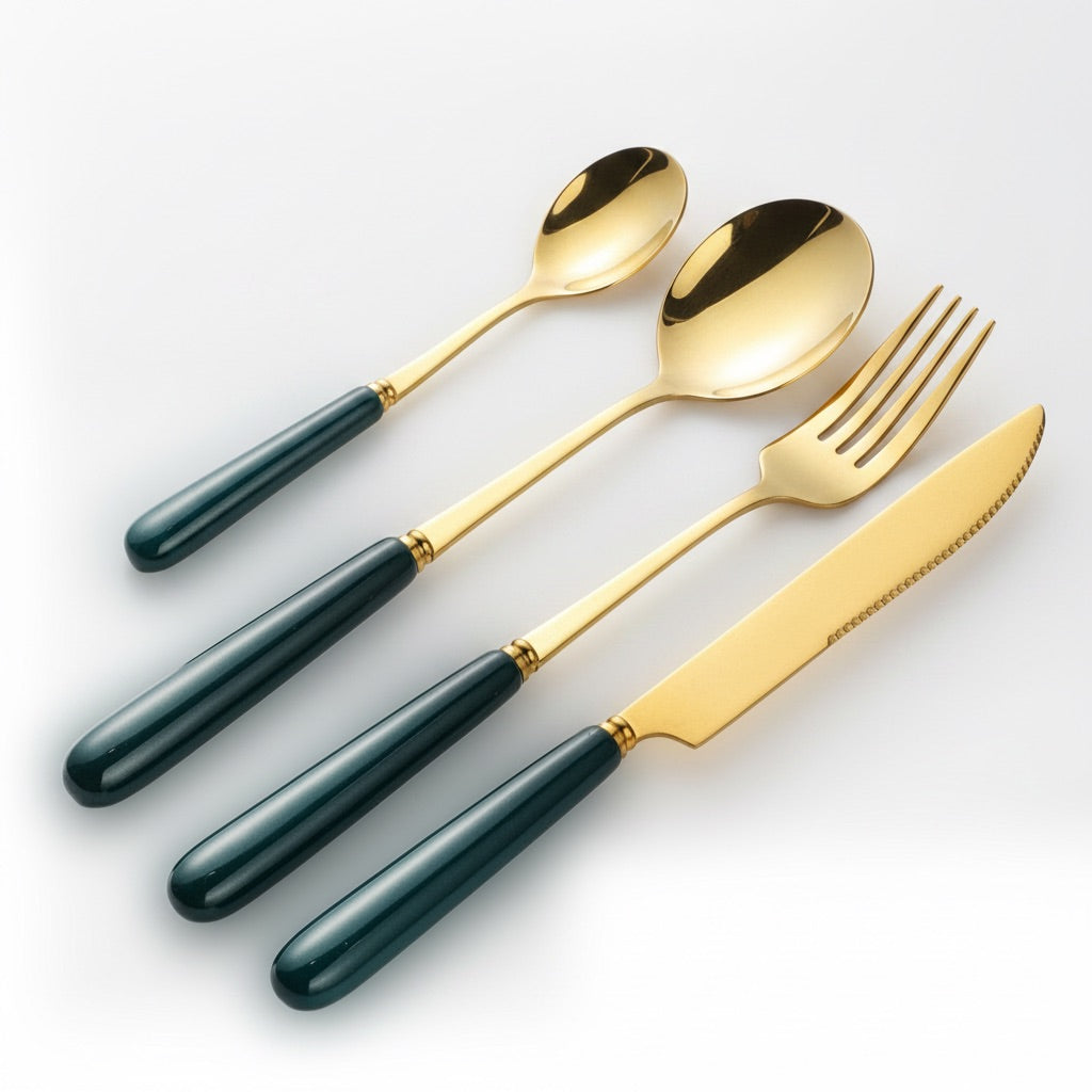 Close-up of KitchBoom Aldermere 24-piece gold cutlery set with ceramic handles in forest green, showcasing elegant design and craftsmanship.
