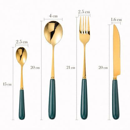 Aldermere 24-piece gold cutlery set by KitchBoom displayed on a table, includes forks, knives, spoons, and serving utensils in forest green packaging.