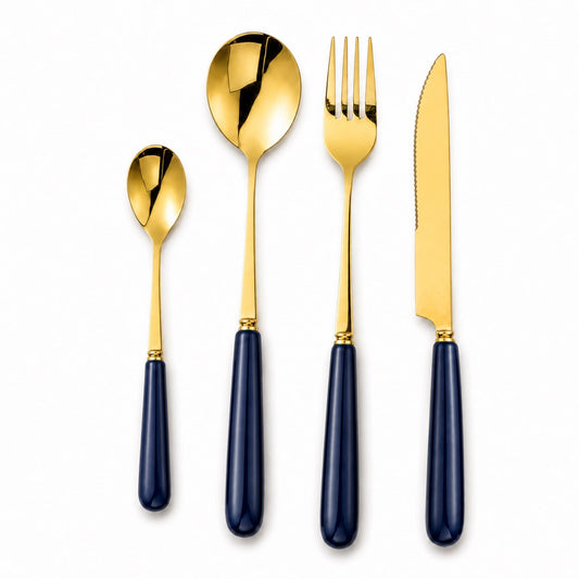 A 16-piece Aldermere gold cutlery set in midnight navy color, including forks, knives, spoons, and serving pieces.