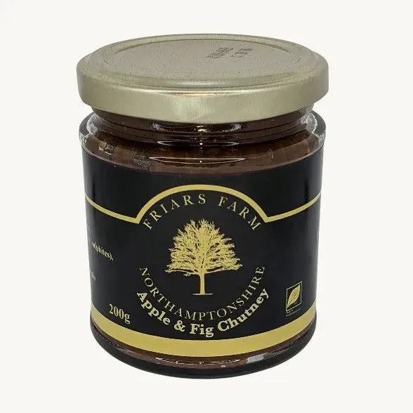 Apple and fig chutney in a jar, featuring chunks of apple and fig with a rich, glossy texture from Friars Farm.