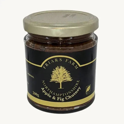 Apple and fig chutney in a jar, featuring chunks of apple and fig with a rich, glossy texture from Friars Farm.
