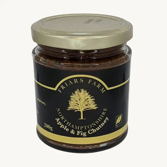 Apple and fig chutney in a jar, featuring chunks of apple and fig with a rich, glossy texture from Friars Farm.