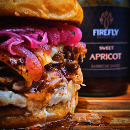 Bottle of FireFly Barbecue Sweet Apricot BBQ Sauce with a label featuring apricots and smoky sauce imagery.