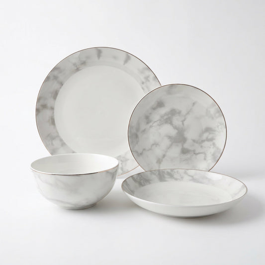 Aurelia 16-piece fine bone china dinner set by KitchBoom, including dinner plates, bowls, and cups arranged on a table.