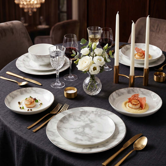 KitchBoom Aurelia 16-piece fine bone china dinner set arranged on a dark table with plates, bowls, and cups for elegant dining.