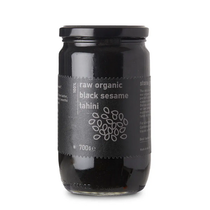 Raw Organic Black Sesame Tahini from Whole Food Earth, a creamy black sesame spread in a glass jar with a natural, textured surface.