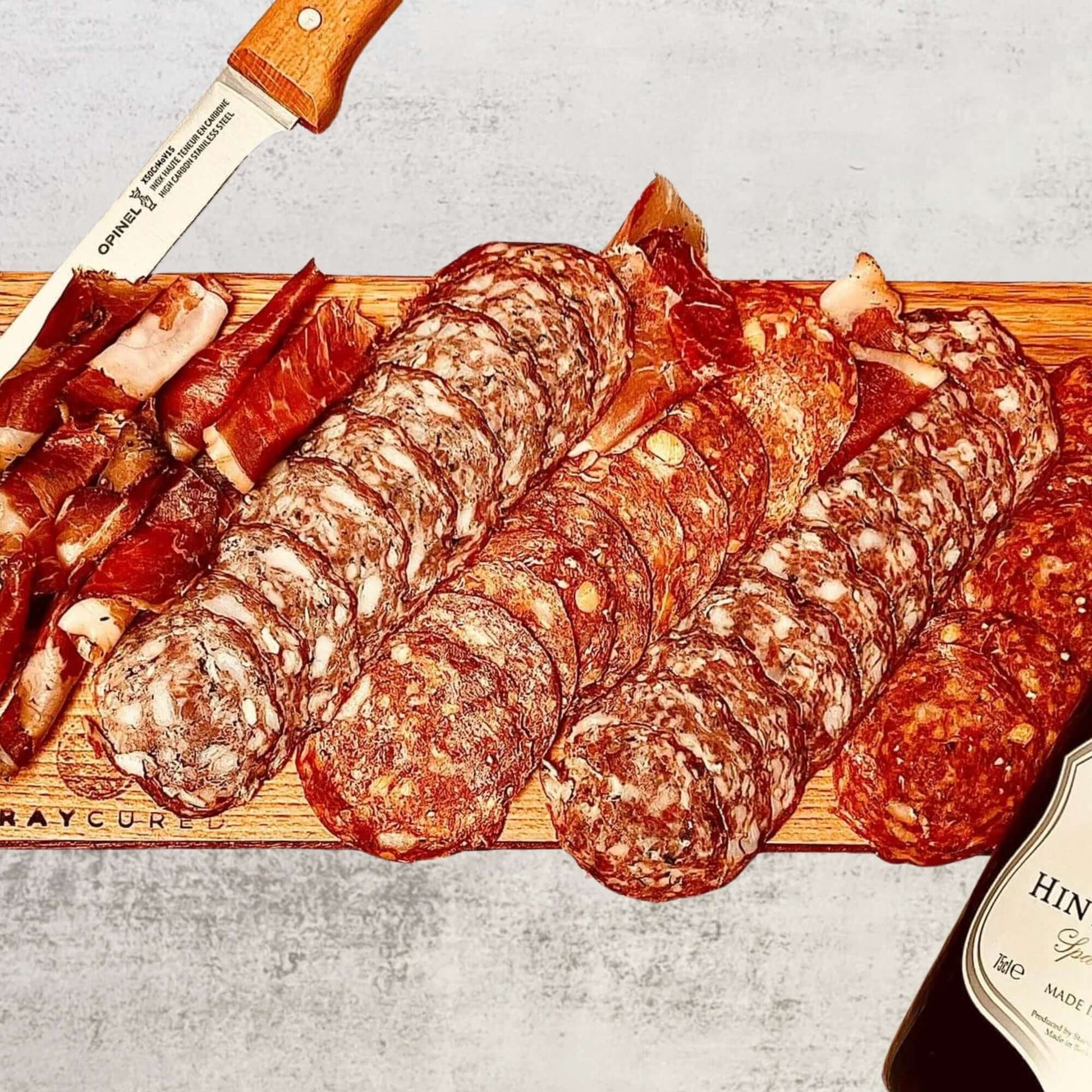 Bray Cured Bacchus Brut and British charcuterie hamper with assorted cured meats, cheeses, and accompaniments on a wooden board.