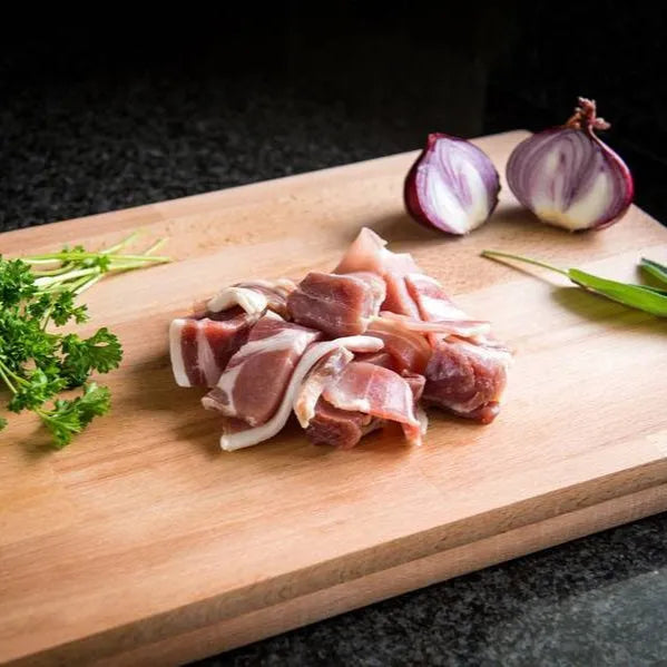 Primrose Herd bacon off-cuts showing a close-up of crispy, irregular bacon pieces with a marbled appearance and smoky texture.
