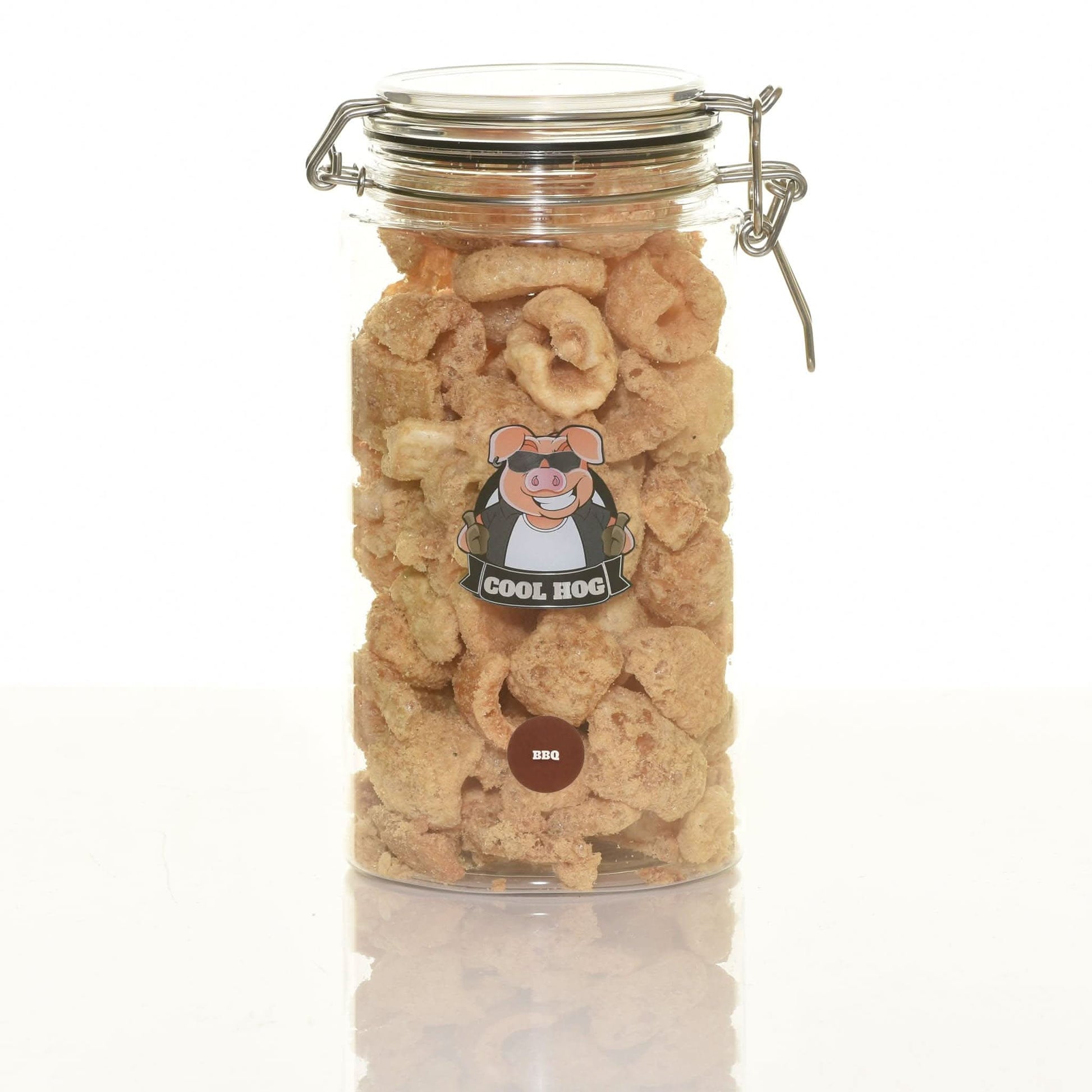 Jar of BBQ flavor pork scratching treats by Cool Hog Snacks, showcasing crispy pork snacks in a clear jar.