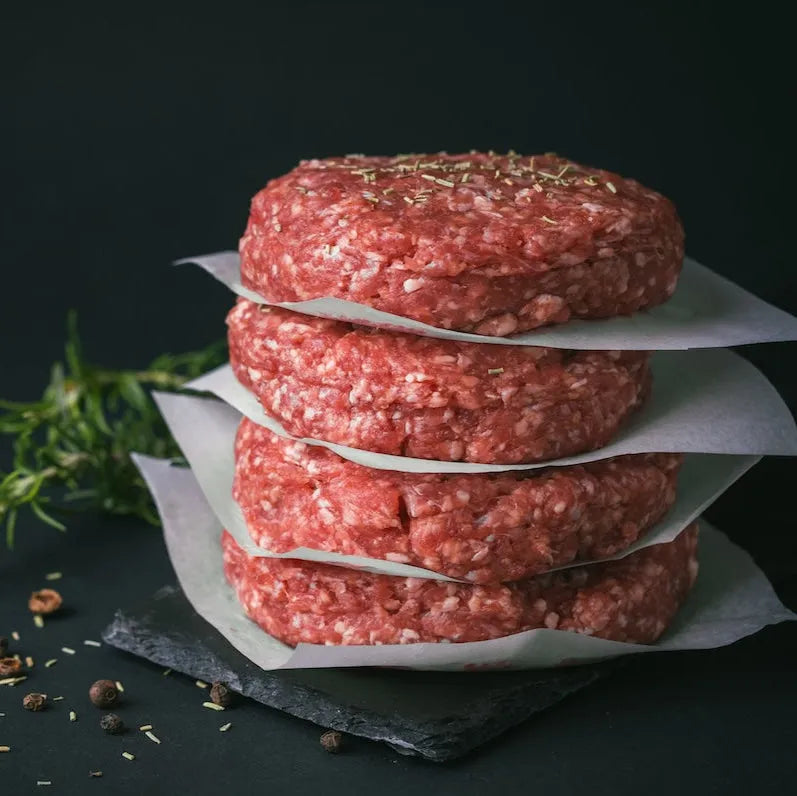 Raw Grass Fed Beef Burgers from Primrose Herd, fresh and uncooked beef patties ready for grilling or cooking.