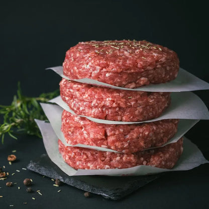 Raw Grass Fed Beef Burgers from Primrose Herd, fresh and uncooked beef patties ready for grilling or cooking.