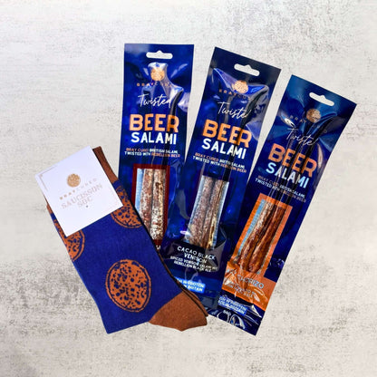 Bray Cured beer salami and saucisson soc packs, sliced and arranged in a charcuterie hamper, showcasing cured meat varieties.