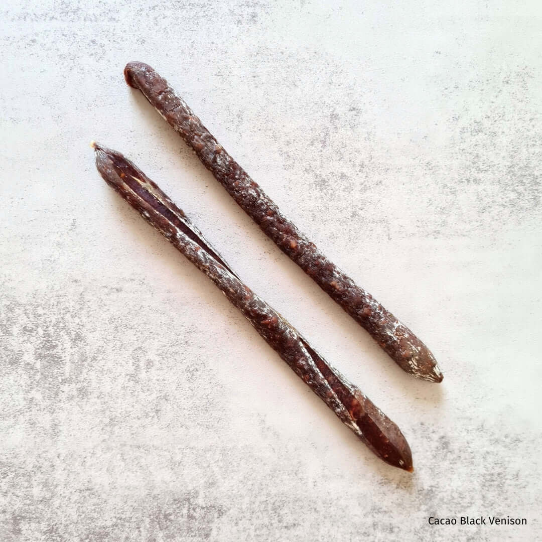 Beer Salami by Bray Cured, charcuterie with black venison, cacao, and spices, displayed on a wooden board with a label.