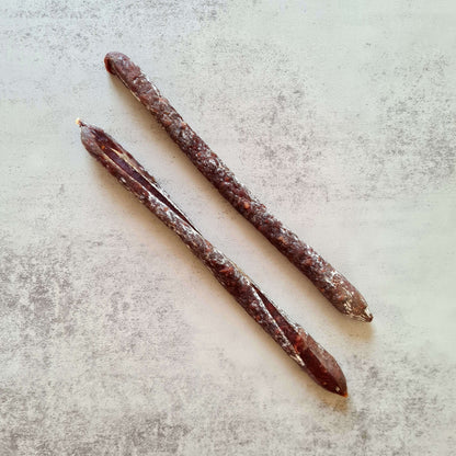 Assorted Bray Cured beer salami and saucisson in a charcuterie hamper, including venison and cacao flavors, displayed on a wooden board.