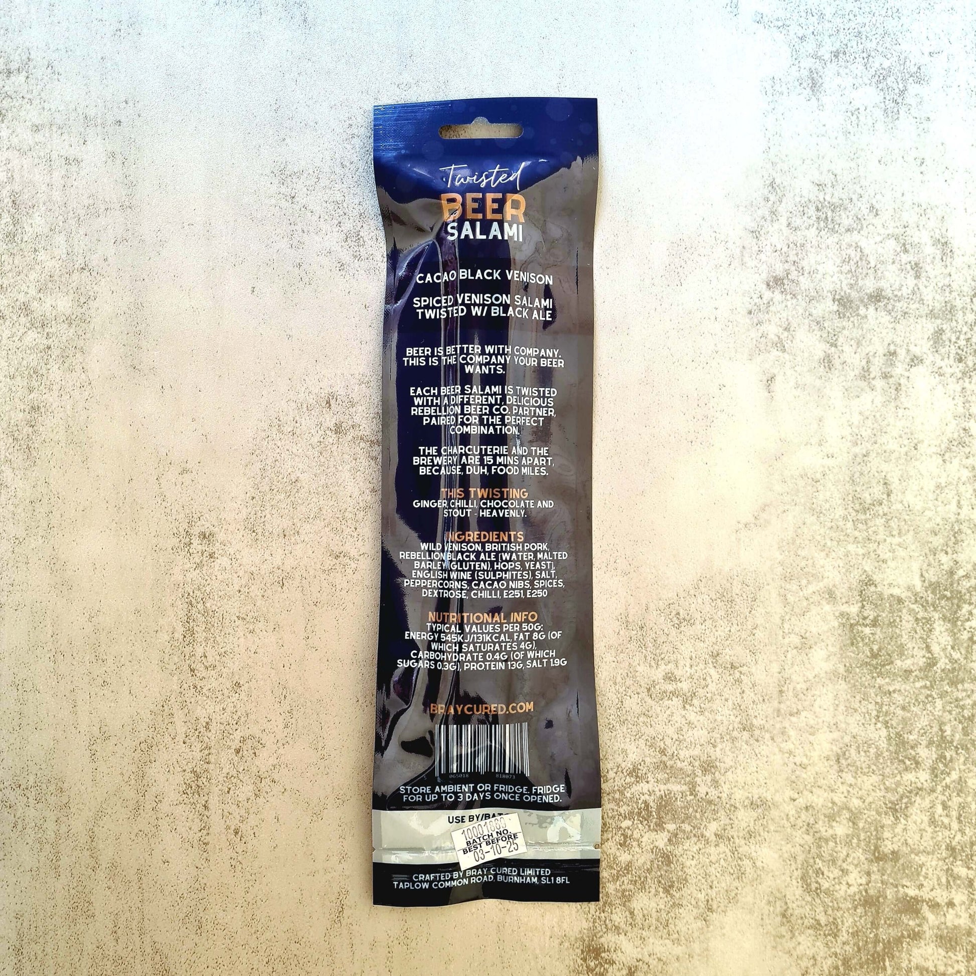 Bray Cured Beer Salami charcuterie pack featuring beer-infused salami and venison with cacao, displayed on a wooden board.