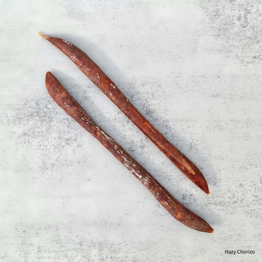 Bray Cured Beer Salami, a hazy chorizo-style charcuterie featuring slices of beer-infused salami on a rustic board.