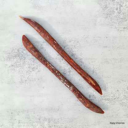 Bray Cured Beer Salami, a hazy chorizo-style charcuterie featuring slices of beer-infused salami on a rustic board.