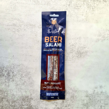 Bray Cured Beer Salami and Merguez charcuterie pack with nuts displayed on a wooden surface.