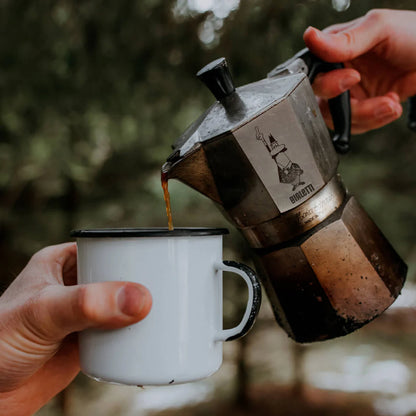 Bialetti Moka Express coffee maker by Brew Italia, outdoor-friendly stovetop espresso pot on a camping table.