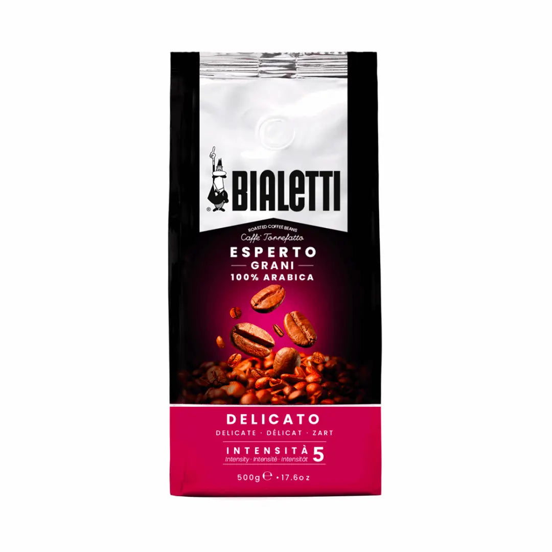 Bialetti Whole Bean Coffee by Brew Italia with whole roasted coffee beans in a clear bag, showcasing the Delicato blend.