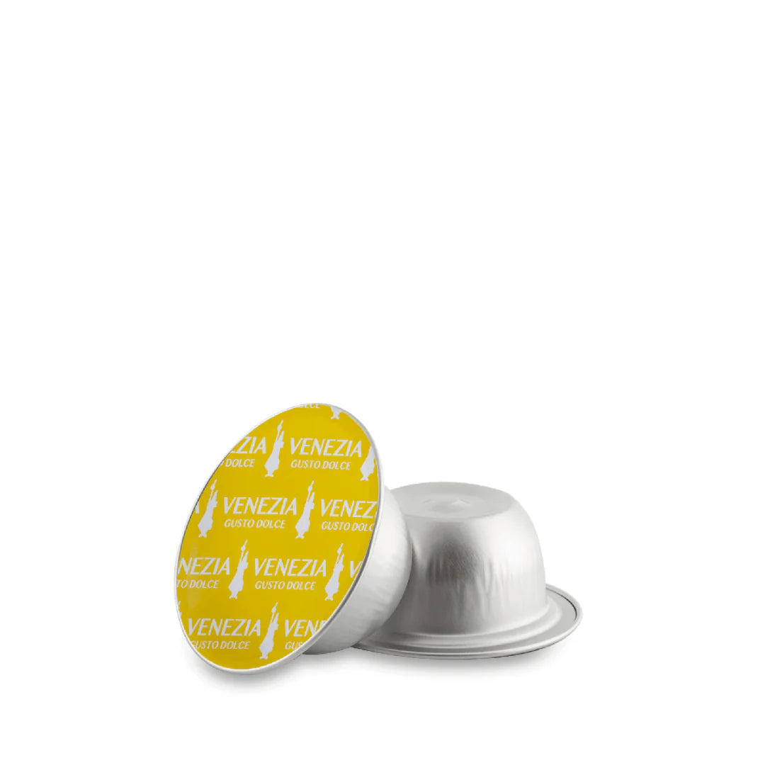 Bialetti Caffe’ d’Italia Gioia compatible coffee capsules by Brew Italia, showing a row of dark roasted coffee capsules.