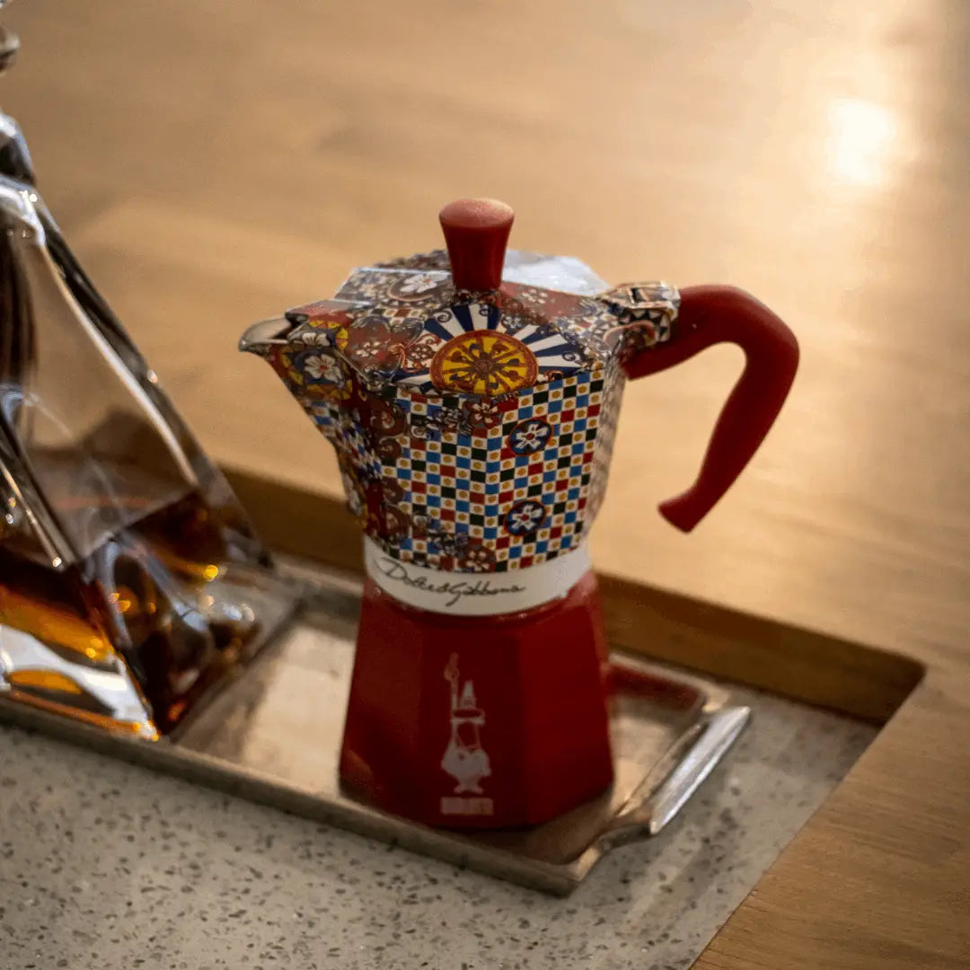 Bialetti X Dolce&Gabbana Sicilian Cart Moka Express coffee maker, with colorful Sicilian-inspired design and Bialetti hardware.